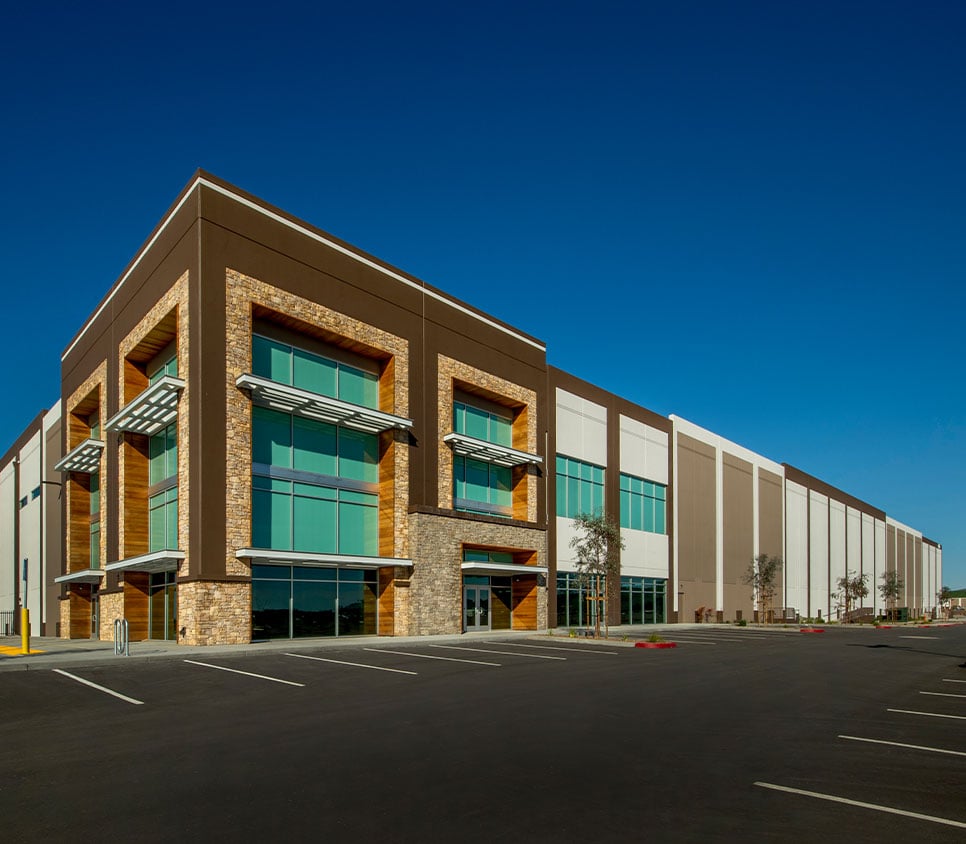 commercial building and parking lot with blue sky above